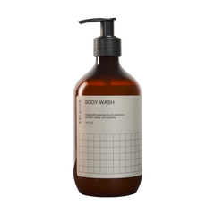 A bottle of Erewhon Body Wash with a pump dispenser. The label shows the brand name and the words 'BODY WASH' in bold, and a grid pattern.