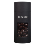 A sleek black canister of Erewhon dark chocolate covered almonds with a window showing the almonds inside.