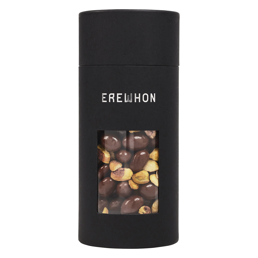 A sleek black canister of Erewhon Organic Pistachios Chocolate Toffee with a window showing the pistachios and chocolate pieces inside.