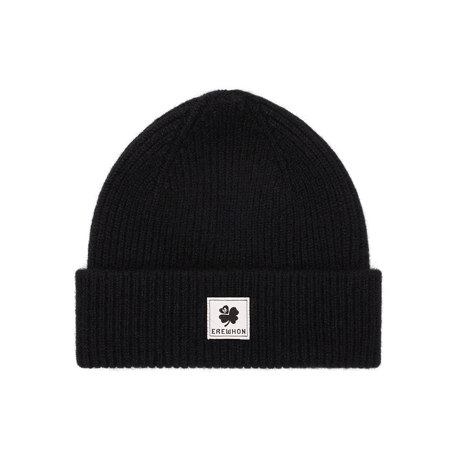 Erewhon black beanie with a white label featuring a clover design on a white background