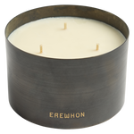 Candle in a black container with 'Erewhon' branding on a white background