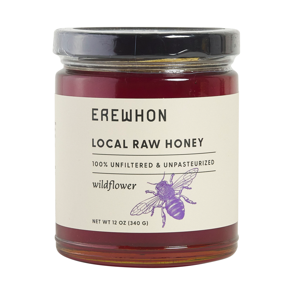 A jar of Erewhon California Wildflower Honey with a label that reads 'Local Raw Honey, 100% Unfiltered & Unpasteurized'. The honey is visible through the clear glass jar and has a dark amber color.