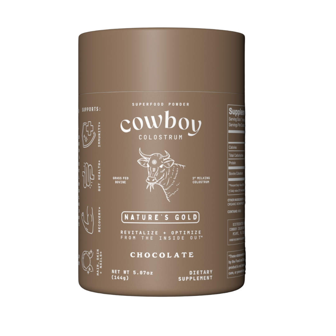 A jar of Chocolate Cowboy Colostrum, a rich and creamy blend of first-milking colostrum with organic cacao, monk fruit, and sea salt for balanced flavor.
