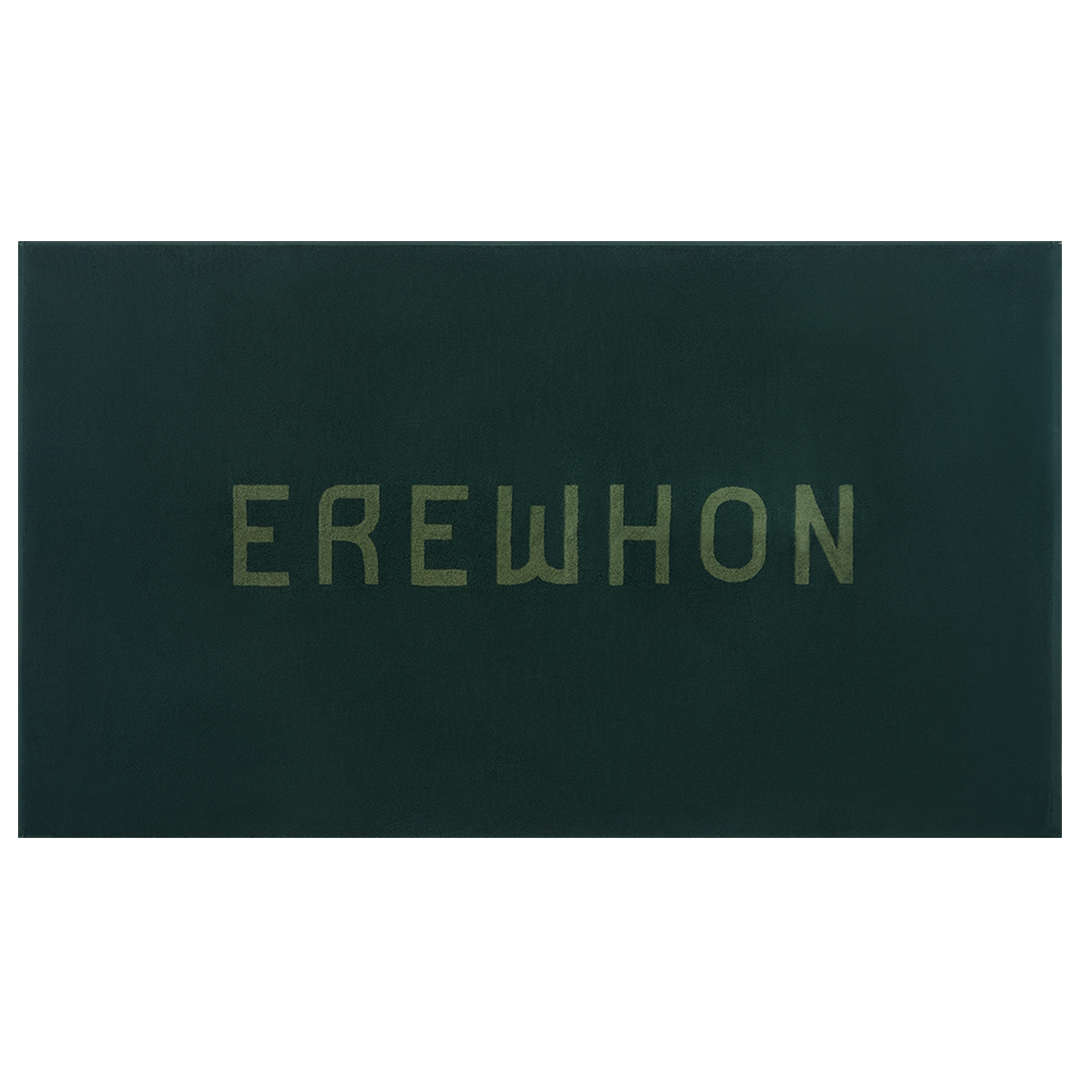 Dark green beach towel 'EREWHON' branding on a white background