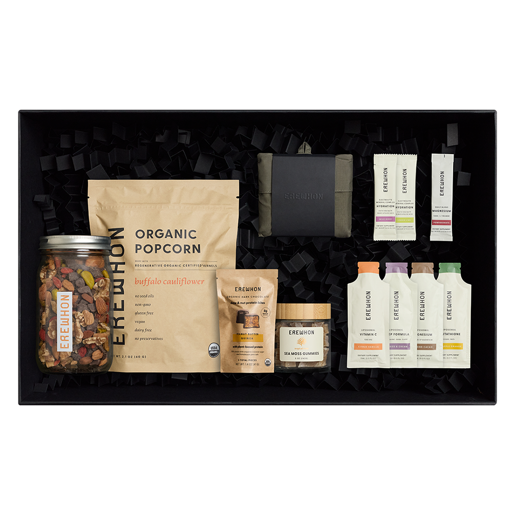 The Erewhon Discovery Gift Box with green nylon ripstop bag, protein date bites, trail mix, sea moss gummies, hydration sticks and liposomal wellness supplements
