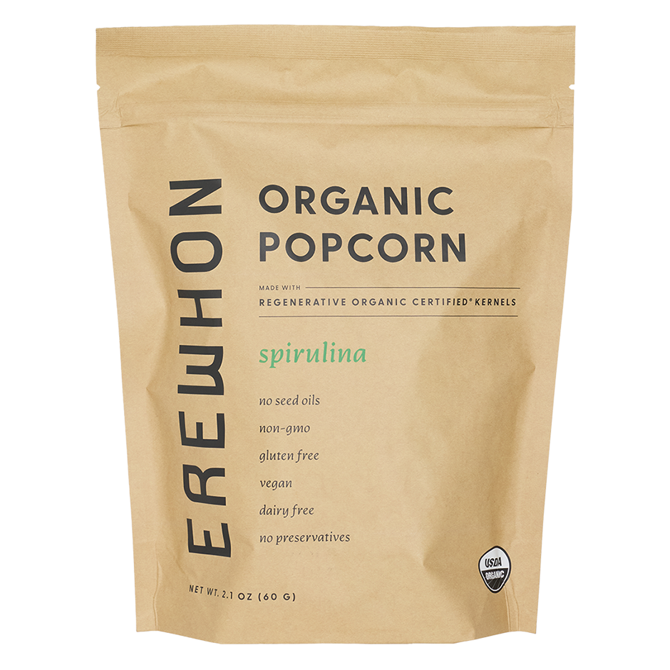 A 2.1 oz kraft paper stand-up pouch of Erewhon Organic Popcorn with Spirulina, featuring black text and a small USDA Organic seal on a white background.
