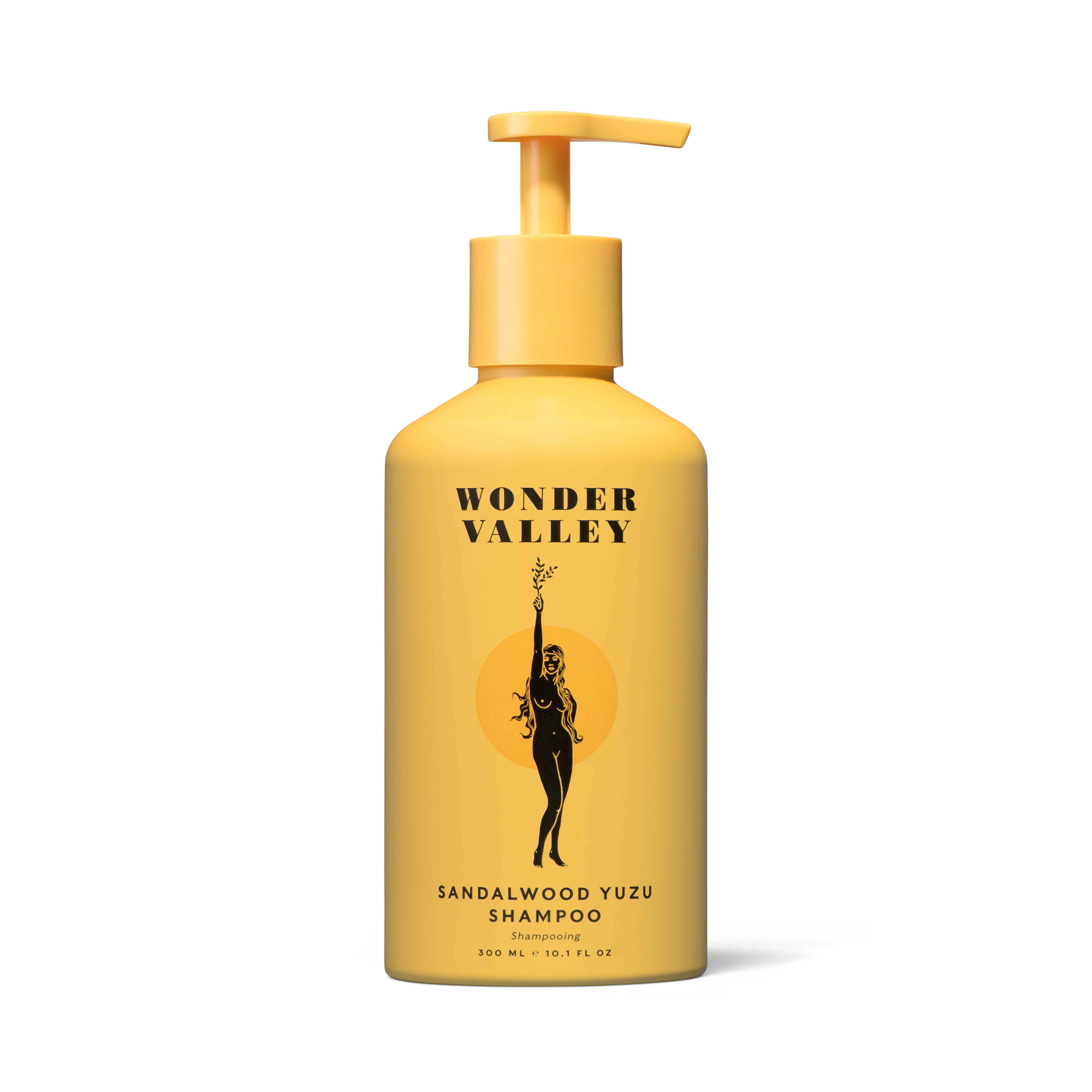 A yellow bottle of Wonder Valley Sandalwood Yuzu Shampoo with a pump dispenser, labeled with the brand and product name.