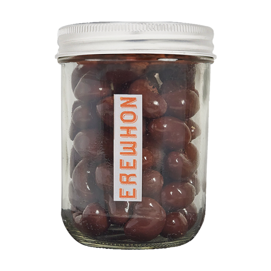 EREWHON jar of Milk Chocolate Covered Cashews with a white lid and 'EREWHON' label on a white background