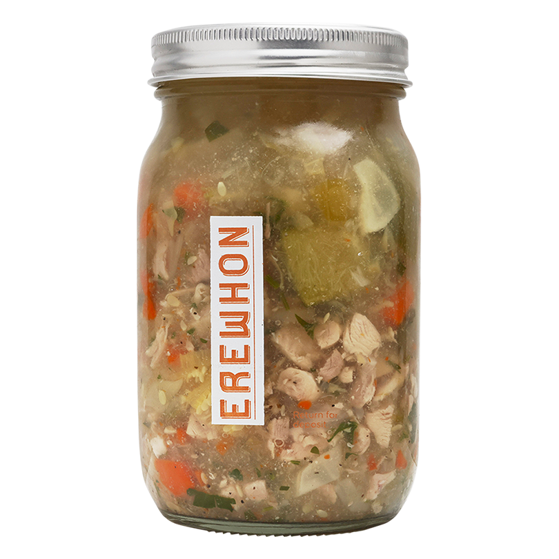 Erewhon Organic Chicken Vegetable Soup Jar of soup with visible ingredients and a brand label on a white background
