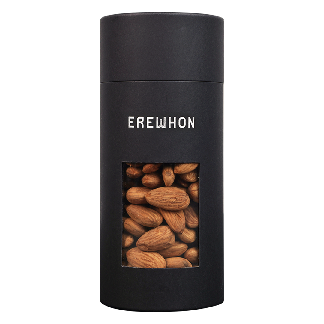 A black canister of Erewhon brand sprouted almonds, with a clear window showing the almonds inside.