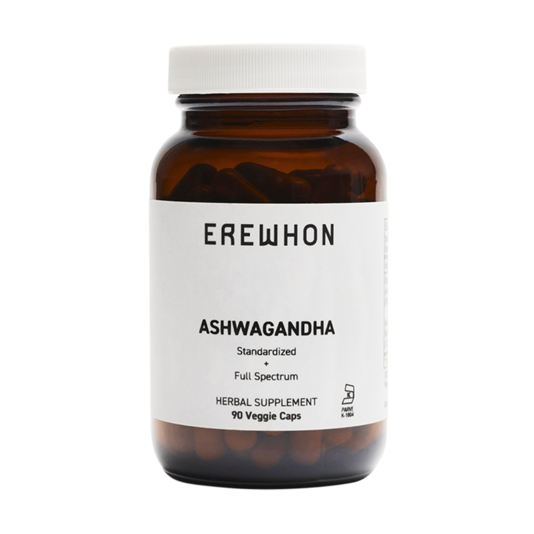 A bottle of Erewhon Ashwagandha capsules, with the label displaying the product name and the number of veggie caps inside.
