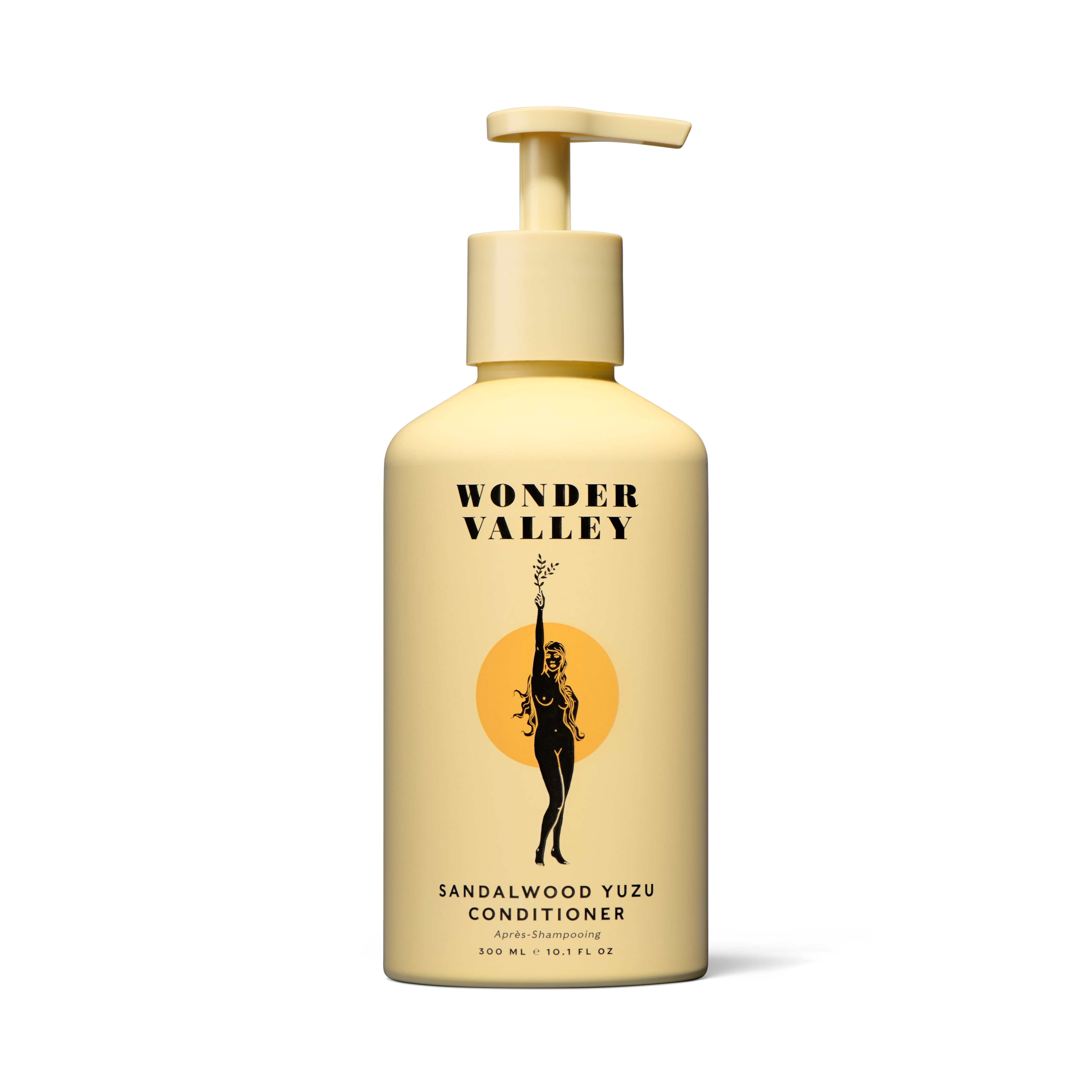 A bottle of Wonder Valley Sandalwood Yuzu Conditioner with a pump dispenser, featuring a minimalist design with a yellow label and aluminum bottle.